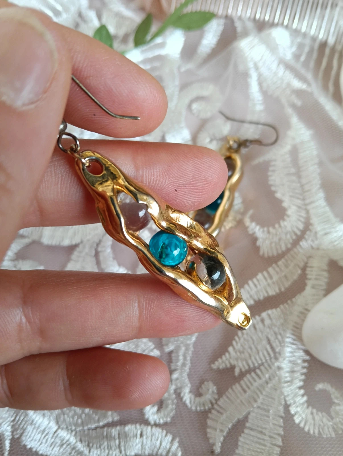 Vintage gold tone pea pod drop earrings with blue smoky glass beads