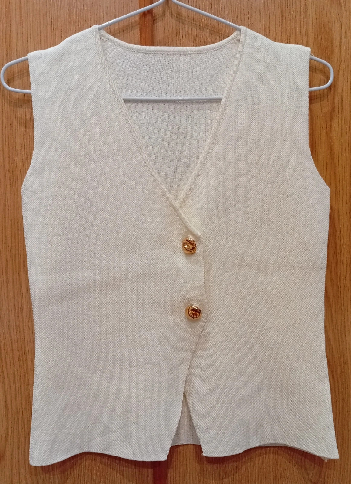 Cream/off-white knitted vest Gold buttons for a chic touch.