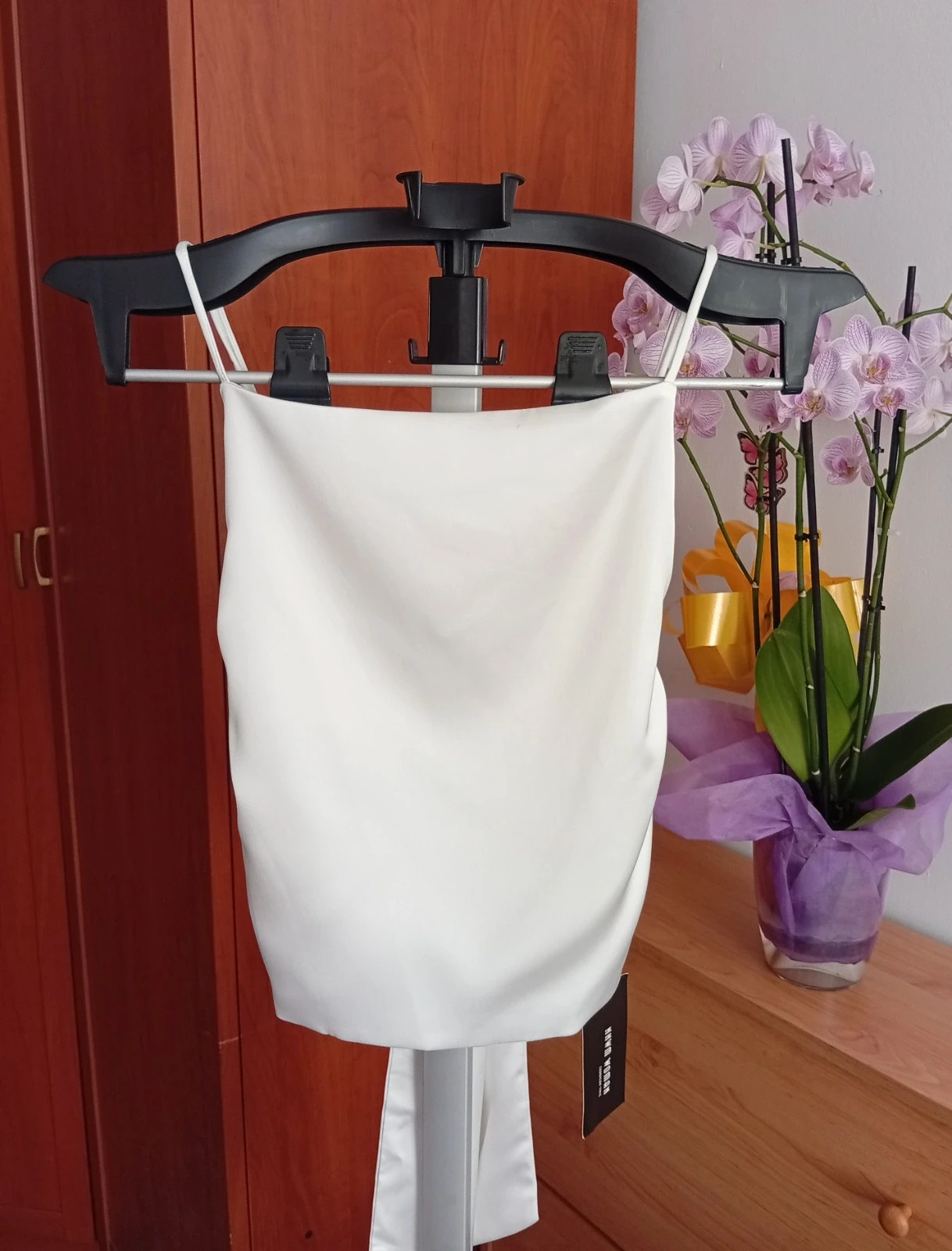 Light cream satin camisole top, size XS. spaghetti straps and beautiful tie-back bow detail.