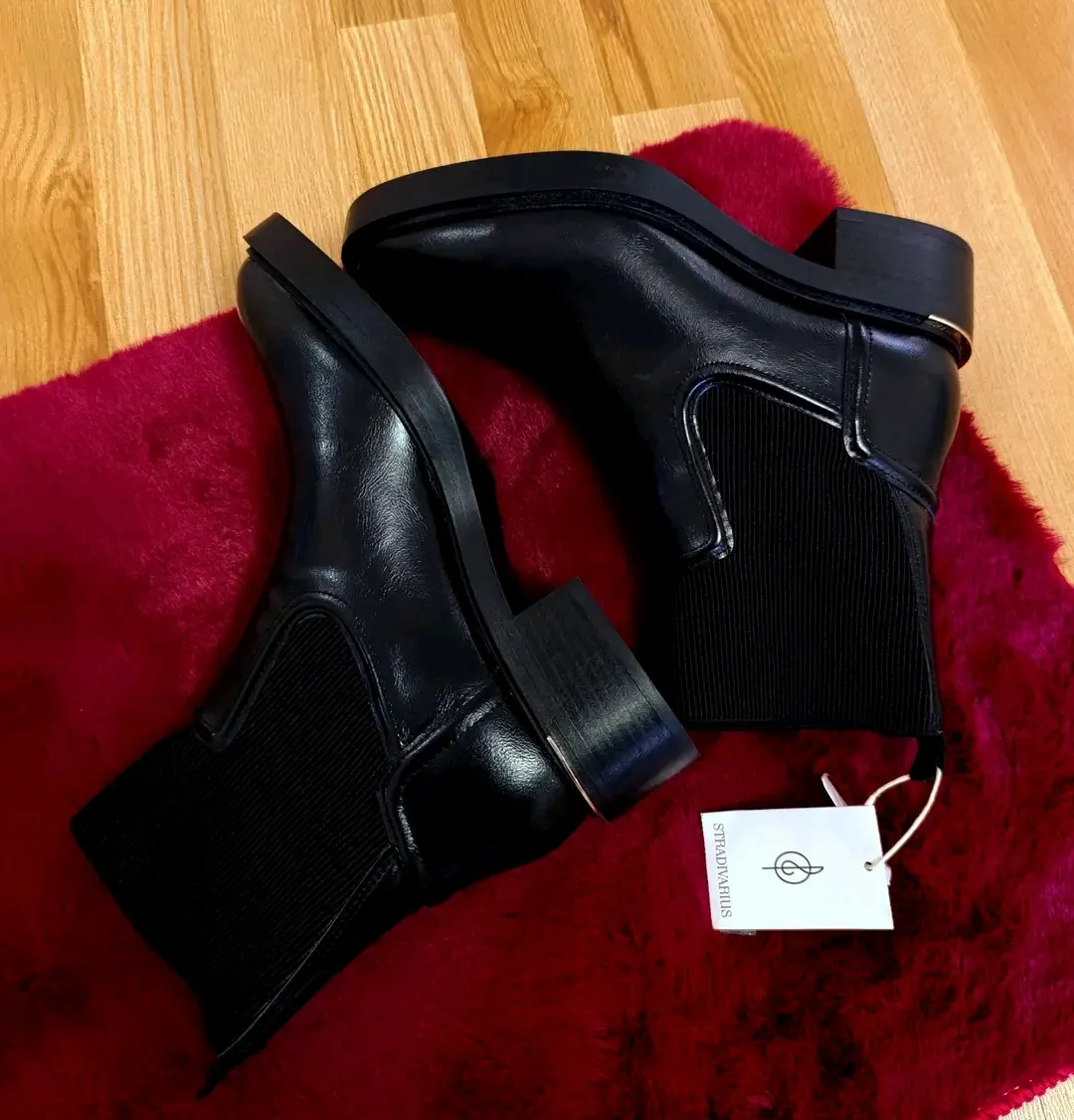 Black leather ankle boots with tag