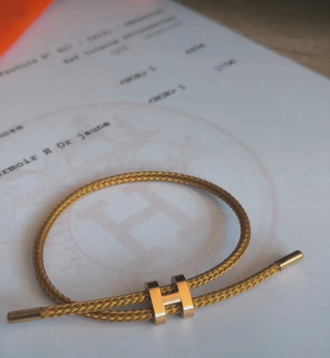 Bracelet jonc tressé doré fermoir H