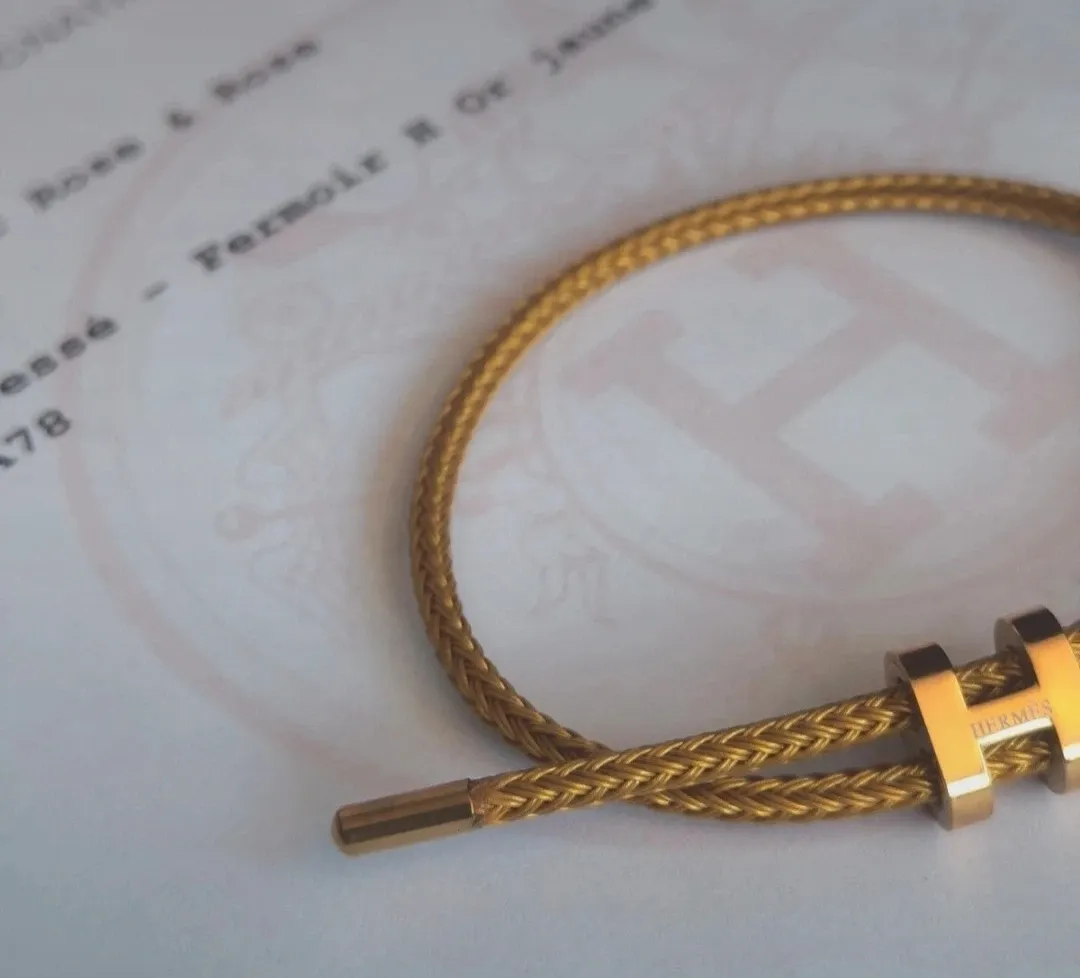 Bracelet jonc tressé doré fermoir H 4