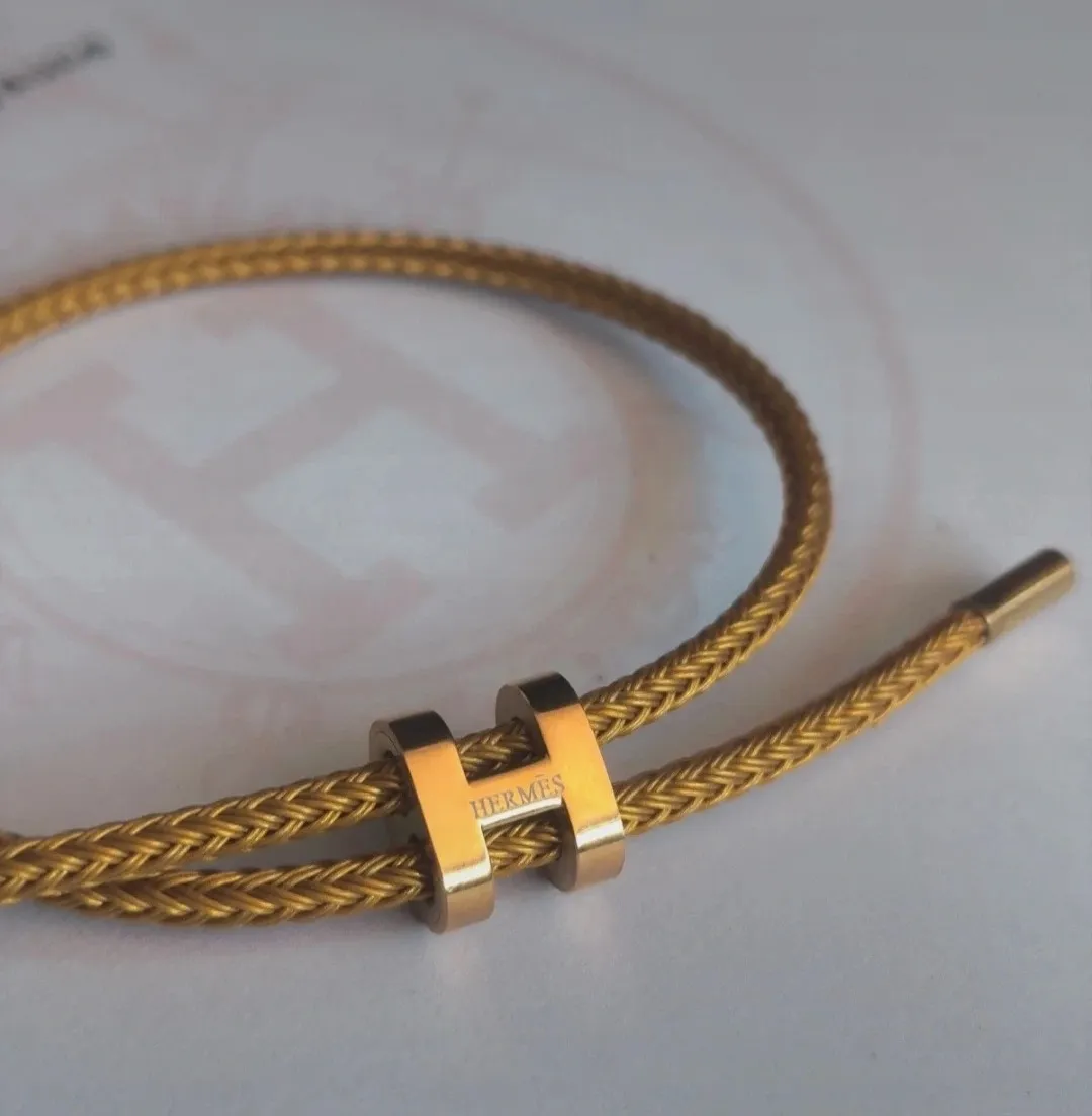 Bracelet jonc tressé doré fermoir H 2