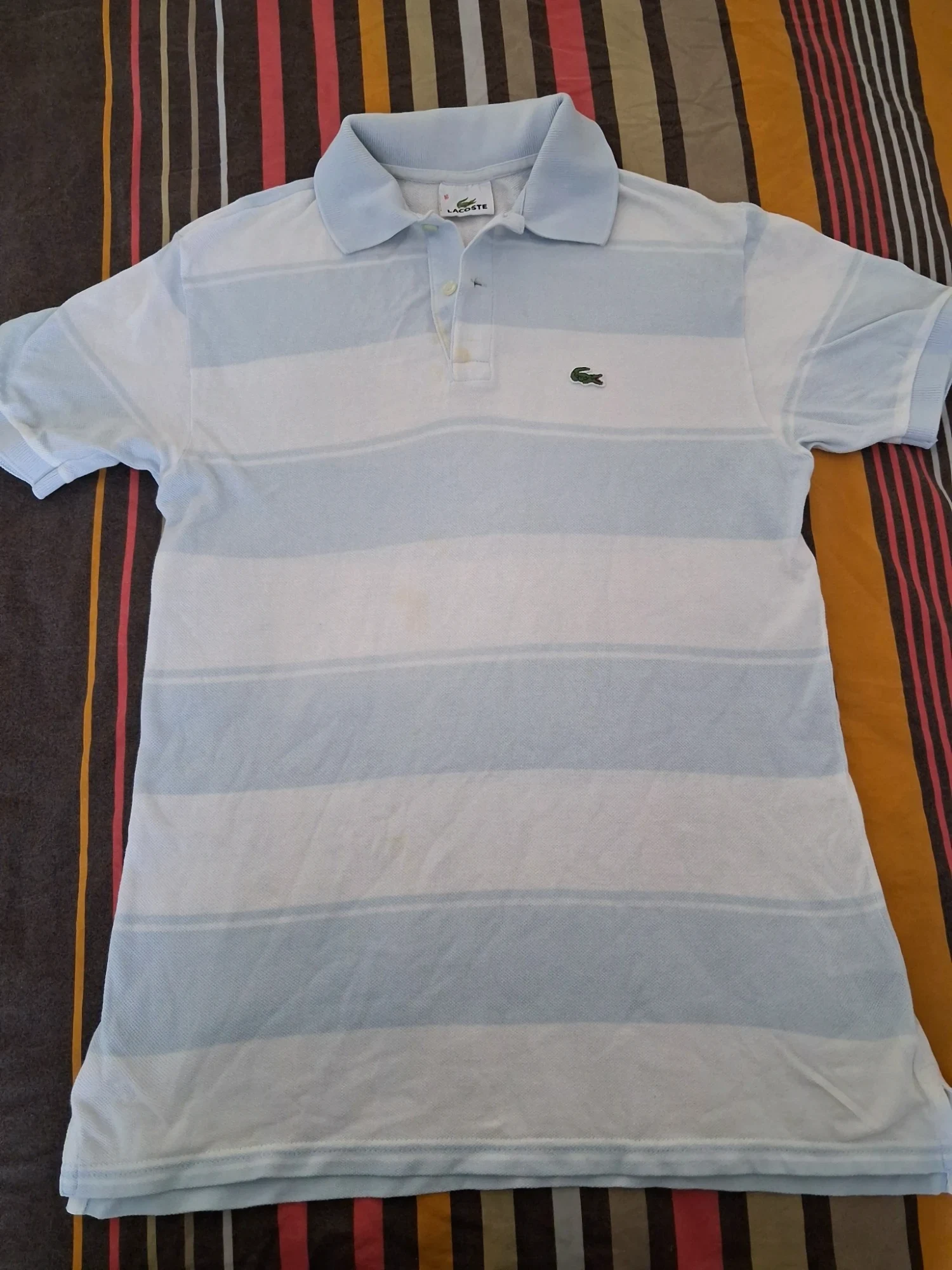Polo Lacoste rayé bleu ciel taille 16