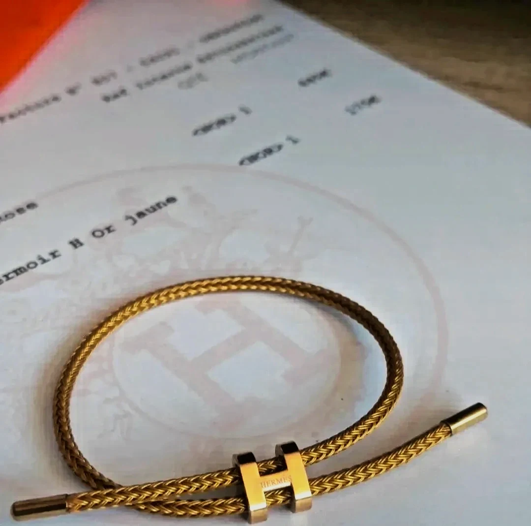 Bracelet jonc tressé doré fermoir H